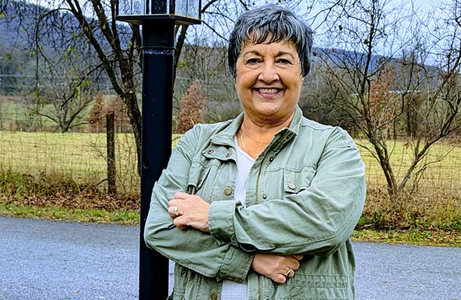 Linda Agostinelli stands outside her home, where she likes to keep busy.