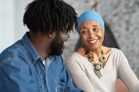 female cancer patient laughing with a young man