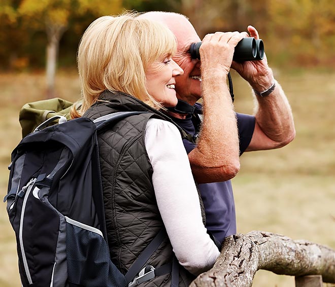Older couple out on a nature hike and spotting wildlife.