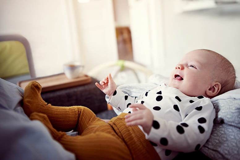 an adorable baby bonding with her mother at home