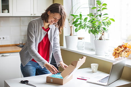 Young woman receiving a package at home.