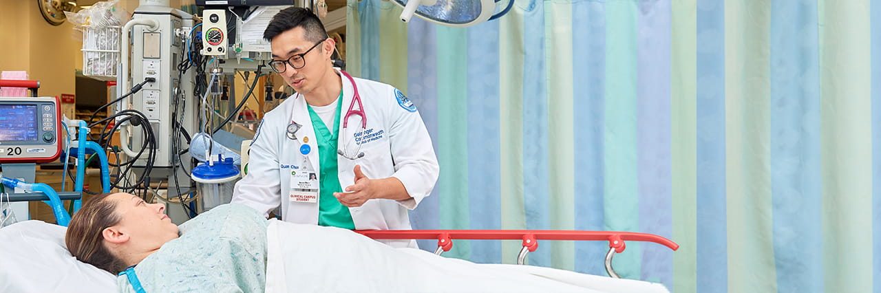 Physician speaking with patient in bed