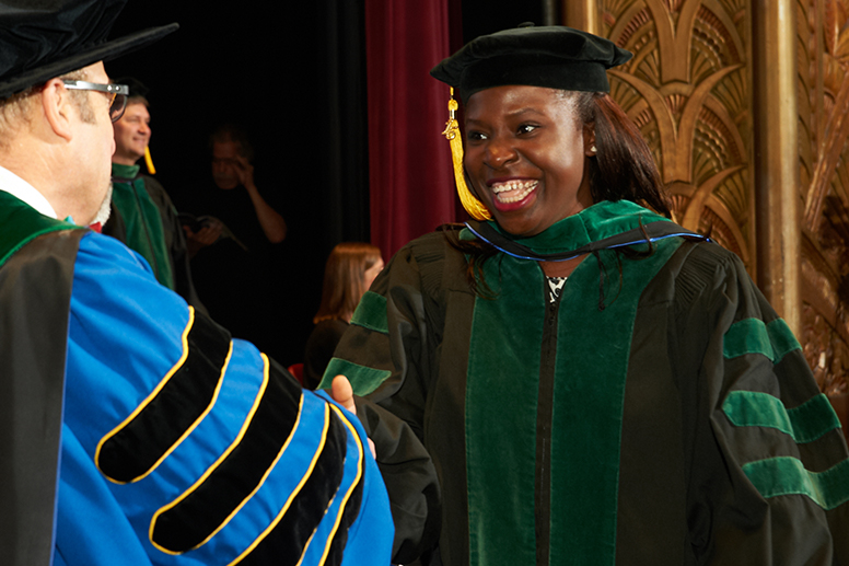 Alumni shaking hands