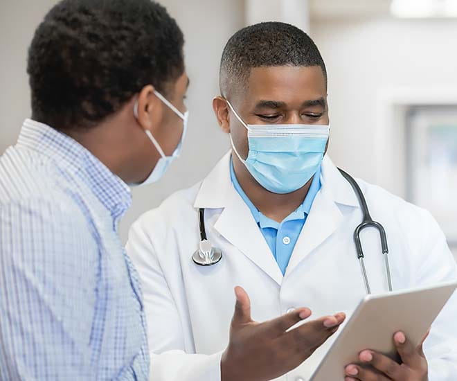 Physician consulting with patient on course of treatment.