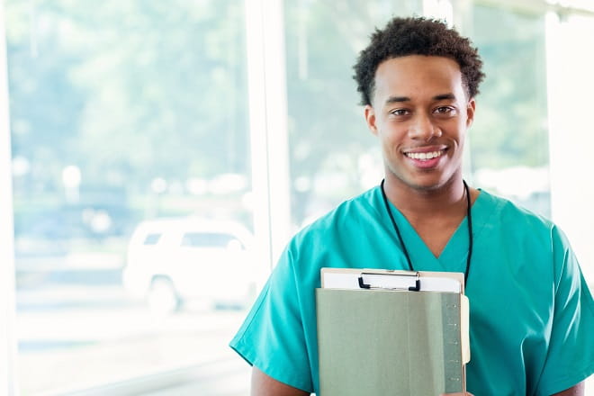 A medical student in front of a window