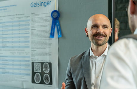 A man smiling talking to a student
