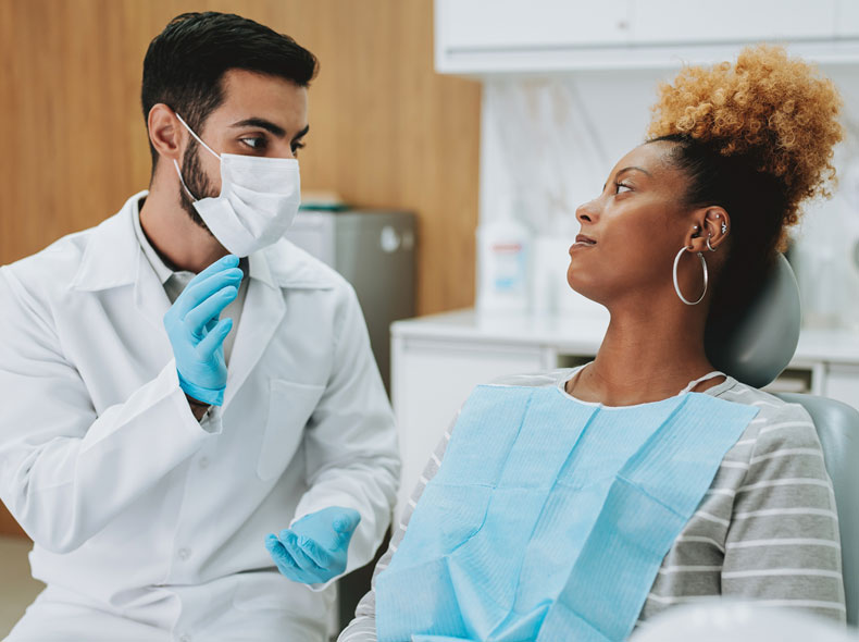 Dentist speaking with patient