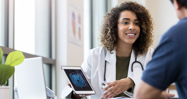 an image of a healthcare worker discussing x-ray scan with patient