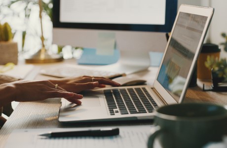a woman typing on a laptop