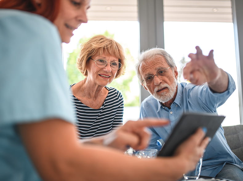 Senior man and woman speaking with doctor