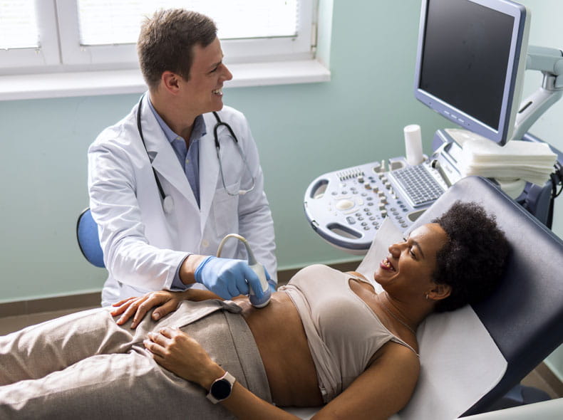 a doctor giving a pregnant patient an ultrasound