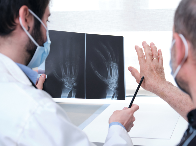 a doctor discussing an x-ray image to a patient