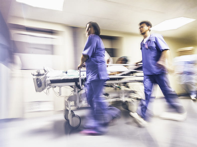 Hospital staff moving a patient