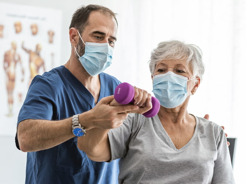 A woman lifting a weight with doctor.