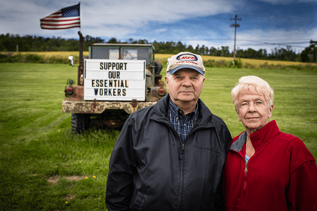 Senior couple stand by support our essential workers sign