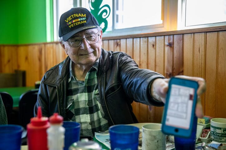 man showing phone screen to camera