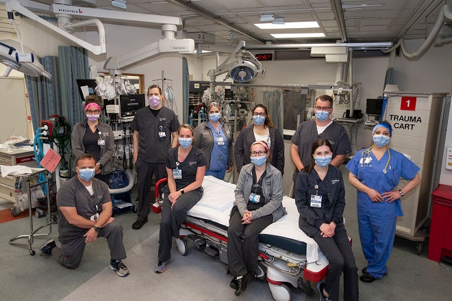 Geisinger nurses posing around a surgical bed in one of many hospital locations