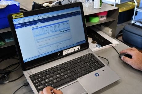 Life Flight maintenance team member logging information into WinAir software.