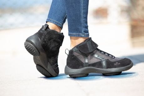 Woman walking with Apos health footgear.