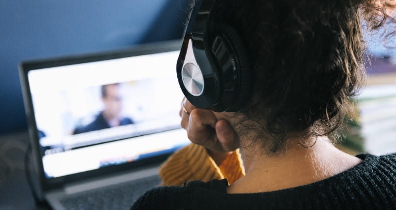 a woman watching a video on her laptop