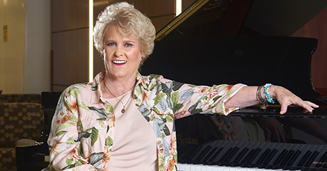 Woman seated at a piano