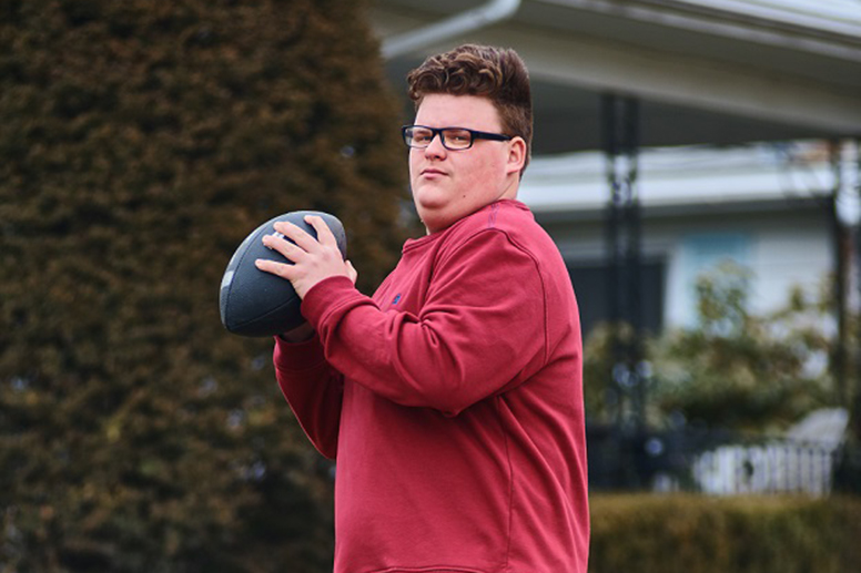 boy throwing football