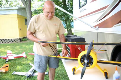 Donald Willits working on a model plane in front of his RV.