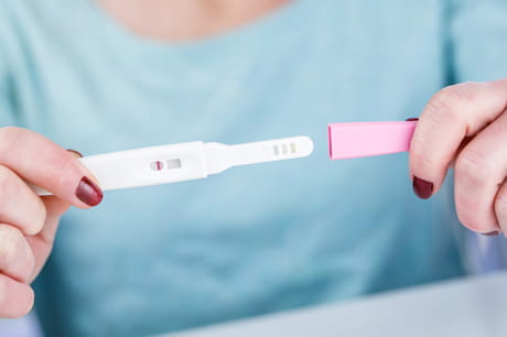 Woman holding pregnancy test