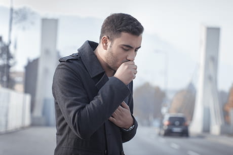 A man coughs.