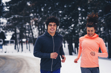 Man and woman running in the winter.