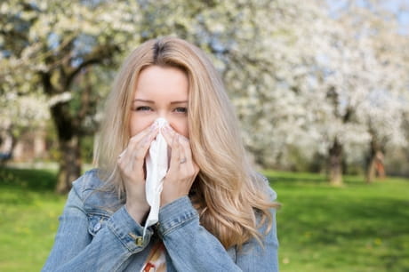 Woman blowing her nose