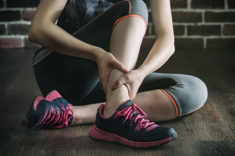 Injured woman holding her ankle