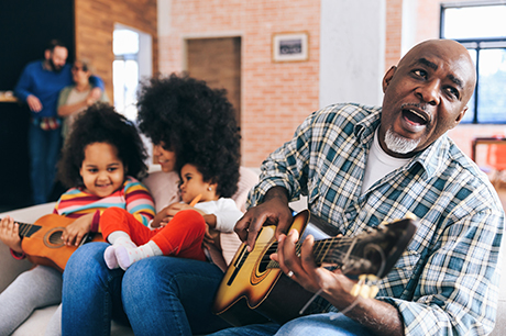 Family sitting on couch singing 