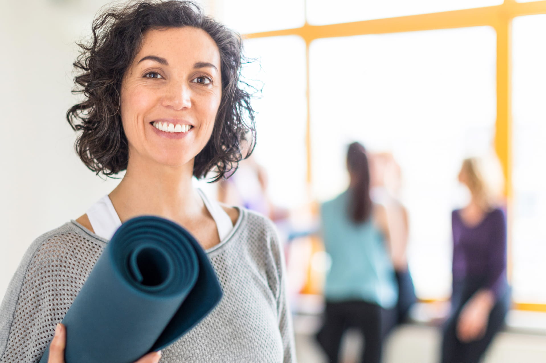 A woman with a yoga mat