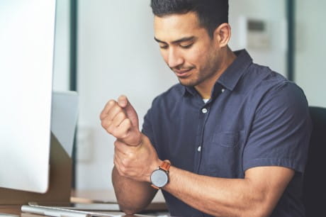A man holding his wrist in pain