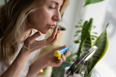 A woman looking at her lips