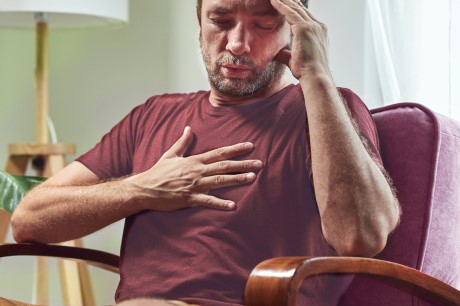 man experiencing fluttering/pain in chest