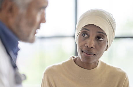 Woman speaking with doctor.