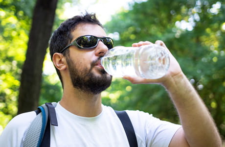 Man drinking a bottle of water. 