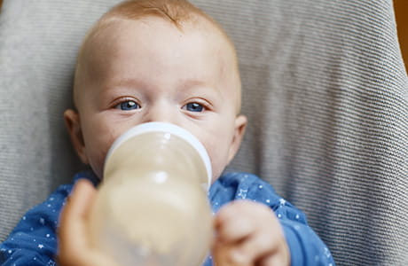 A baby drinking a bottle of milk