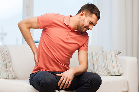 Seated man reaching for his back