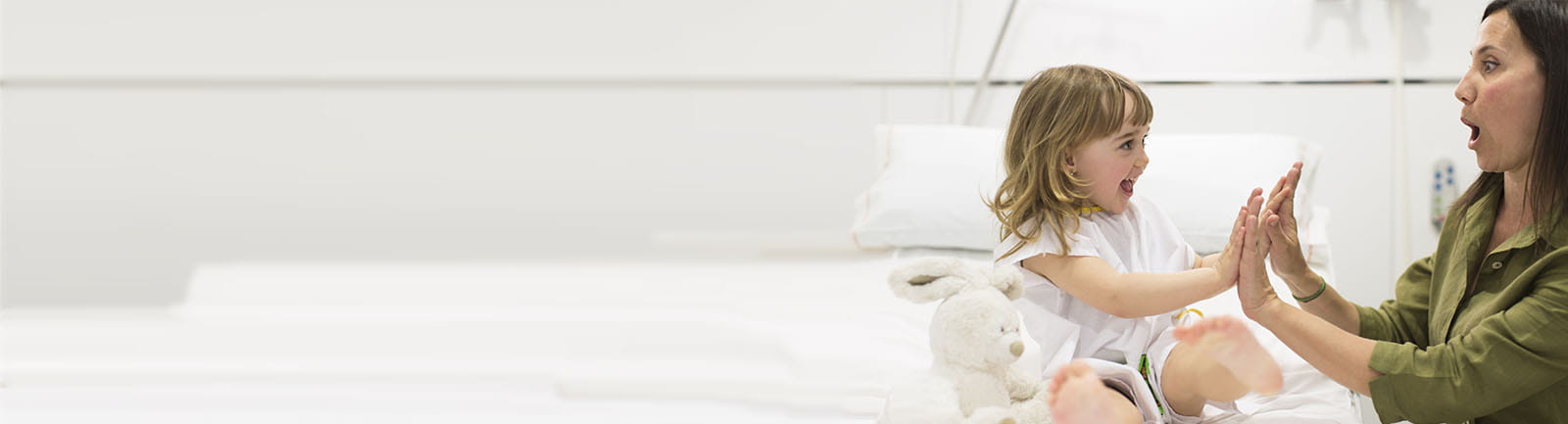 Young girl and mother in hospital bed