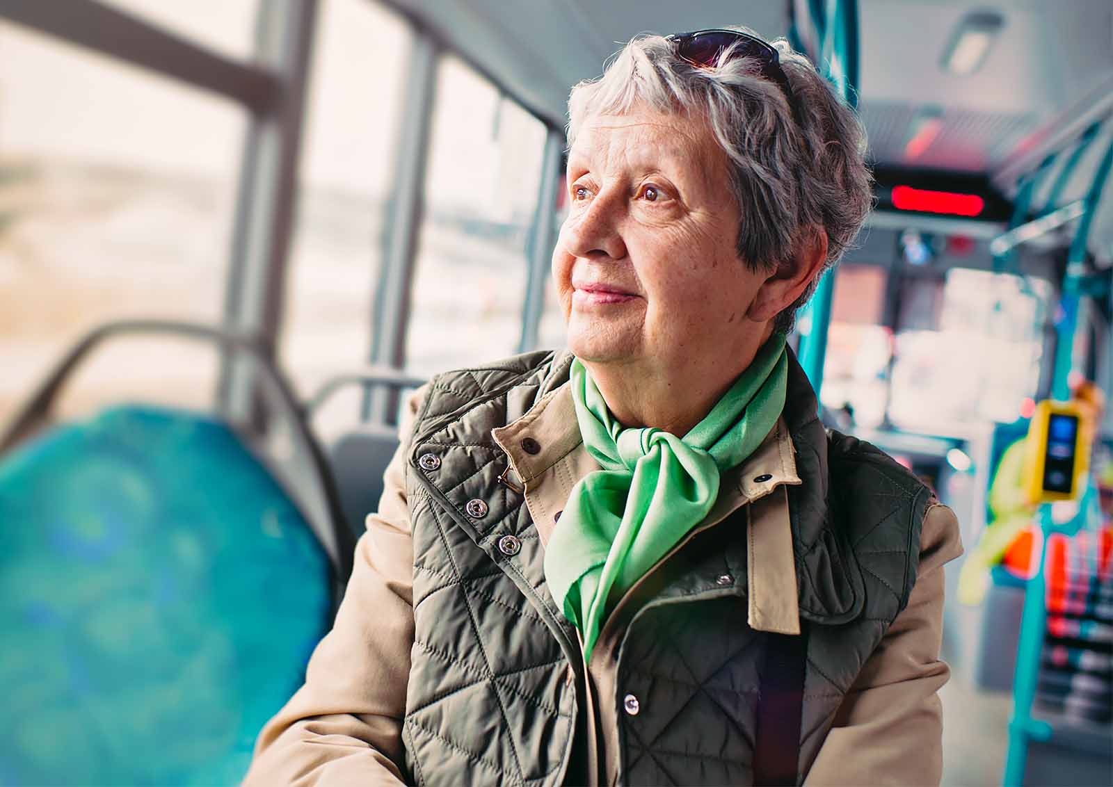 An elderly takes a rides on public transportation.