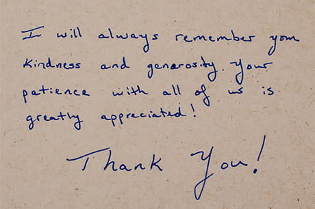 Handwritten thank-you note for participation in medical education on a beige background.