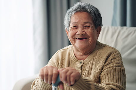 An elderly woman enjoys living independently in her home.