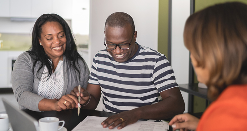 an image of a man and woman talking to an insurance provider