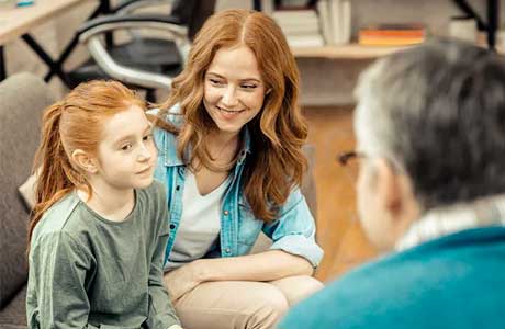 A mother and daughter talking to a lab specialist