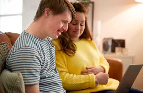 a couple looking at a laptop screen